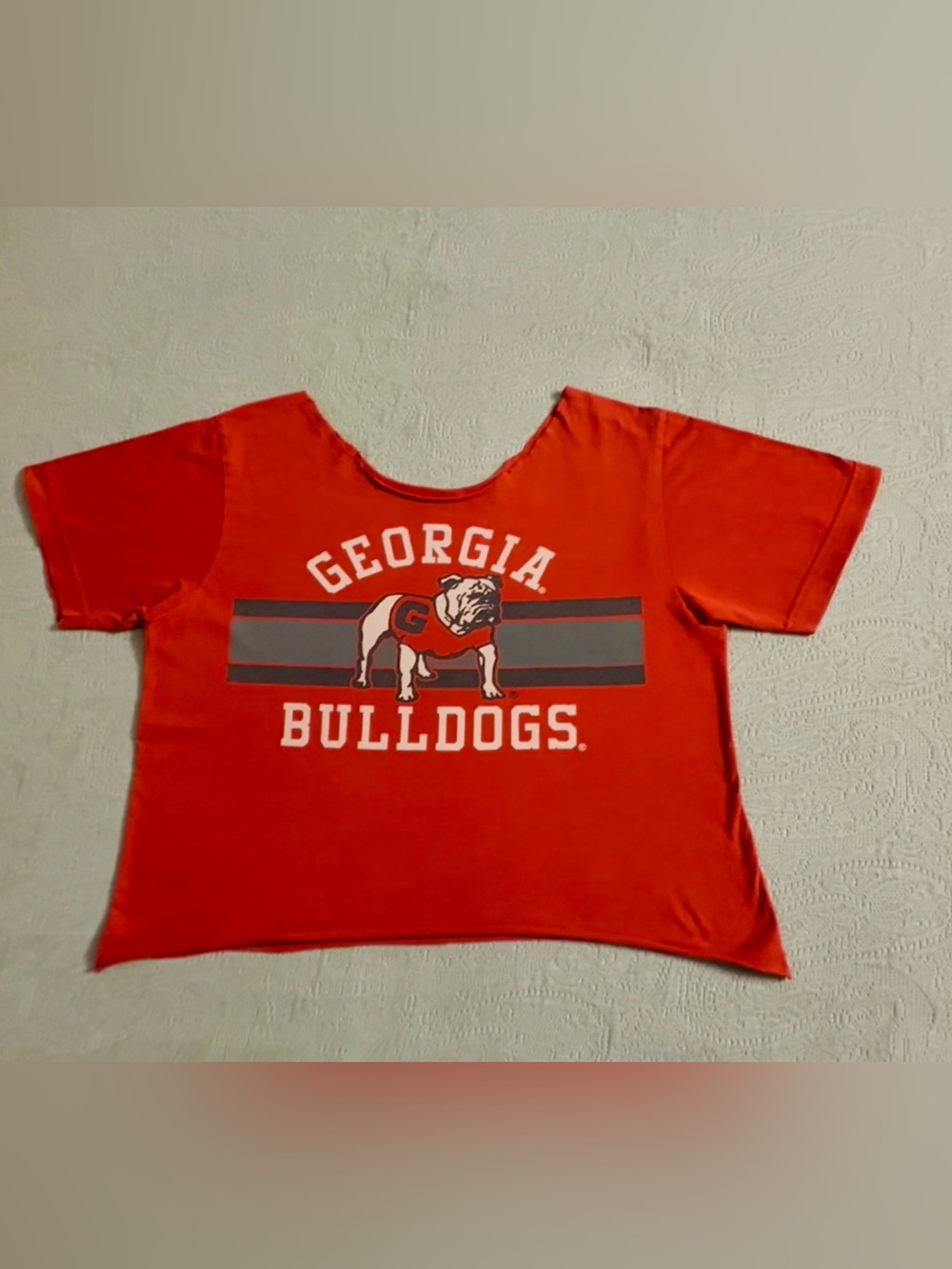 UGA women’s cropped cut- off tshirt, red w/front graphics, gently used.